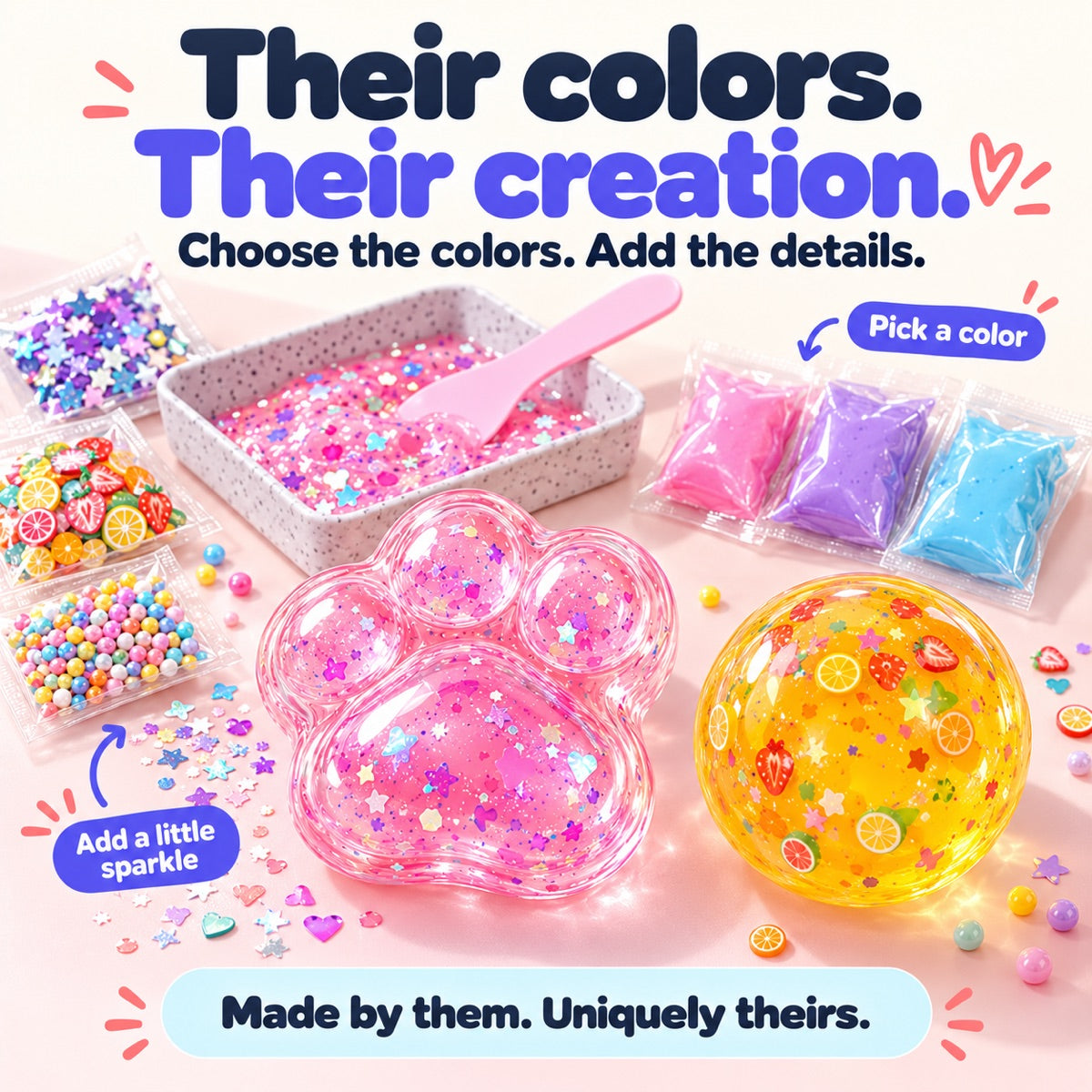 Pink paw and yellow fruit-filled squishy beside colorful slime sachets, sparkles and mixing tray.